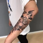 svart och grå tatuering på blomma